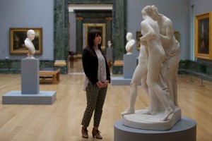 A-member-of-the-gallery-staff-poses-for-a-picture-as-she-looks-at-exhibits-during-a-press-preview-at-the-Tate-Britain-in-London